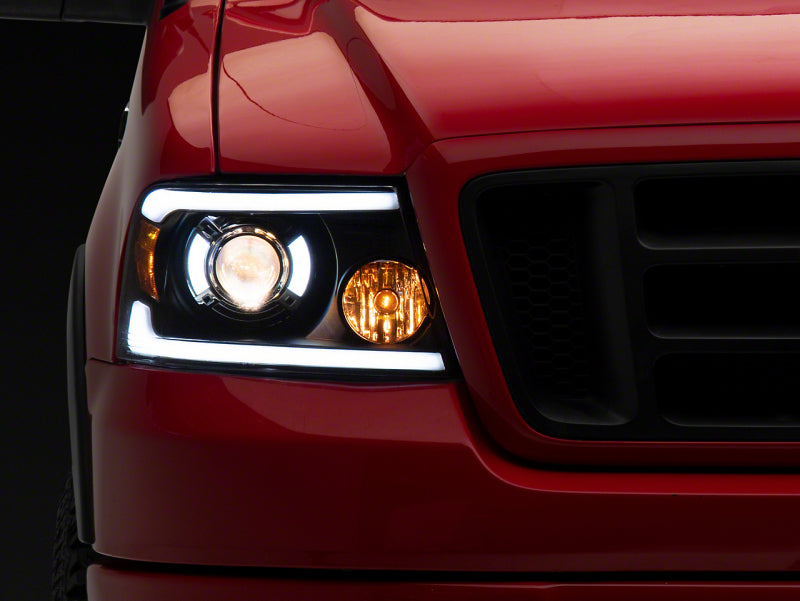 Raxiom 04-08 Ford F-150 Axial Series Projector Headlights with LED Bar- Black Housing- Clear Lens - T566363 for 2004-2008 Ford F 150 - front view
