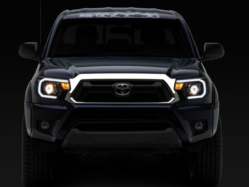 Raxiom 12-15 Toyota Tacoma Axial Series Projector Headlights w/ LED Bar- Blk Housing (Clear Lens) - TT21849