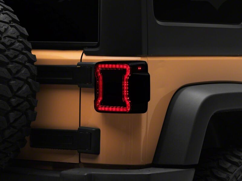 Raxiom 07-18 Jeep Wrangler JK Axial Series JL Style LED Tail Lights- Black Housing- Smoked Lens - J183257 - front view