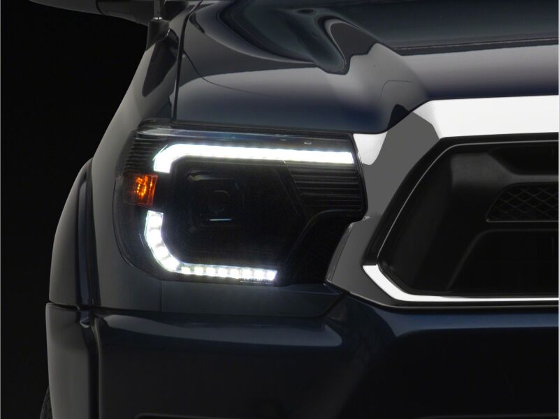 Raxiom 12-15 Toyota Tacoma Axial Series Switchback Projector Headlights- Black Housing- Clear Lens - TT23359 - close-up view