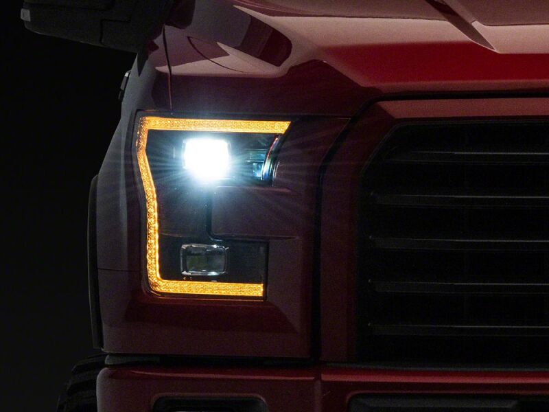 Raxiom 15-17 Ford F-150 LED Projector Headlights with LED Amber DRL- Black Housing- Clear Lens - T558778 - front view