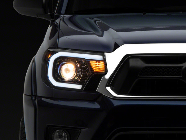 Raxiom 12-15 Toyota Tacoma Axial Series Projector Headlights w/ LED Bar- Blk Housing (Clear Lens) - TT21849 for 2012-2015 Toy