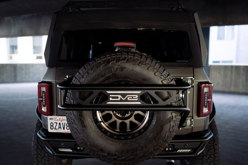 DV8 Offroad 21-23 Ford Bronco Spare Tire Guard &amp; Accessory Mount - TCBR-01